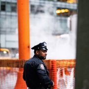 A police officer stands by a construction zone.